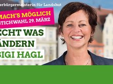 Sigi Hagl vor Landshuter Häusern am Isargestade und daneben die Schrift "Mach's möglich. Stichwahl 29. März - Echt was ändern - Sigi Hagl"