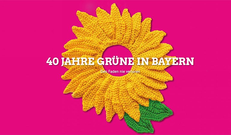 40 Jahre Grüne in Bayern - den Faden nie verloren. Bild mit gestrickter Sonnenblume