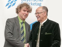 Bezirksrat Markus Scheuermann gratuliert Josef Mederer (rechts) - Foto: Wolfgang Englmaier, Bezirk Oberbayern